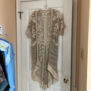 Long Cardigan Sweater with Beautiful crochet work. It is cream and light beige